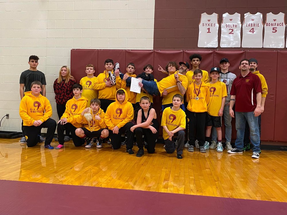 The MS Wrestling team wearing gold G-A hoodies and t shirts
