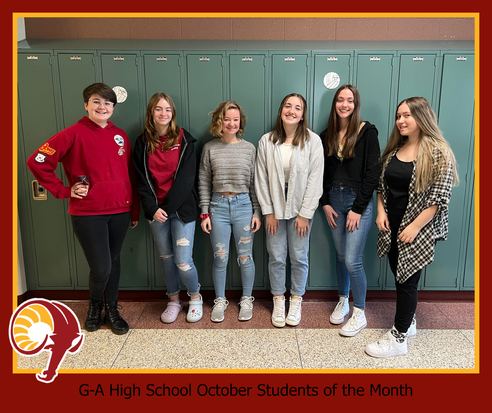 The October students of the month standing in front of lockers in the High School