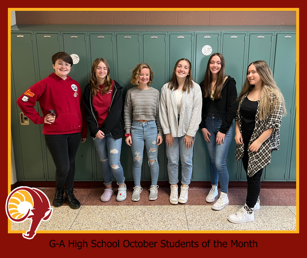 Six of the October 2021 High School Students of the Month smiling and standing in front of lockers at the High School